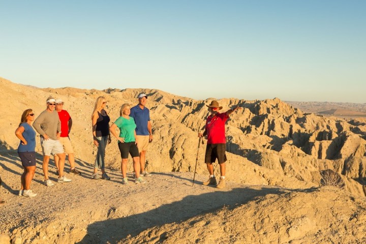 a group of people on a beach posing for the camera