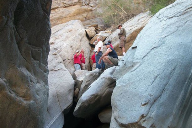 a group of people sitting on a rock